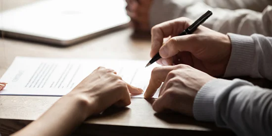 Couple signing their mortgage loan agreement.